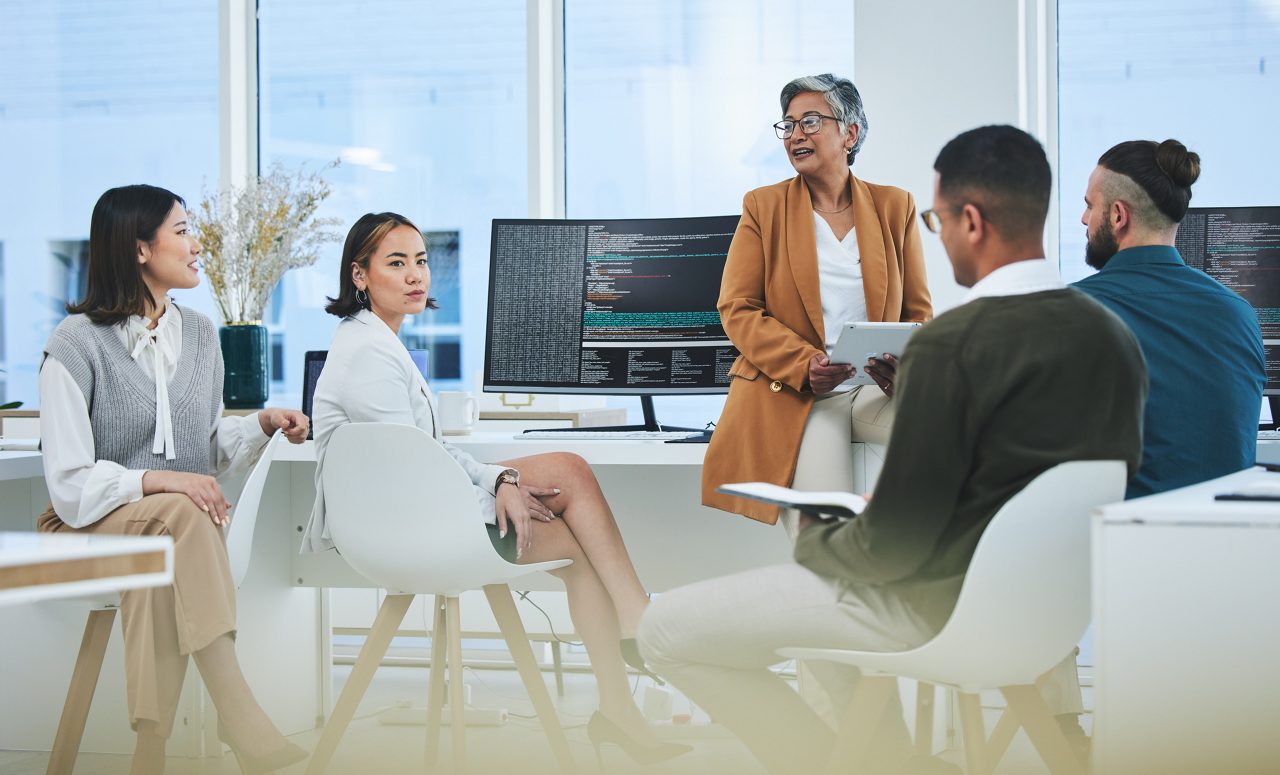 Meeting, mentor and programmer with business people in office for coding, developer or information technology. Teamwork, code review and feedback with employees in digital agency for it cybersecurity