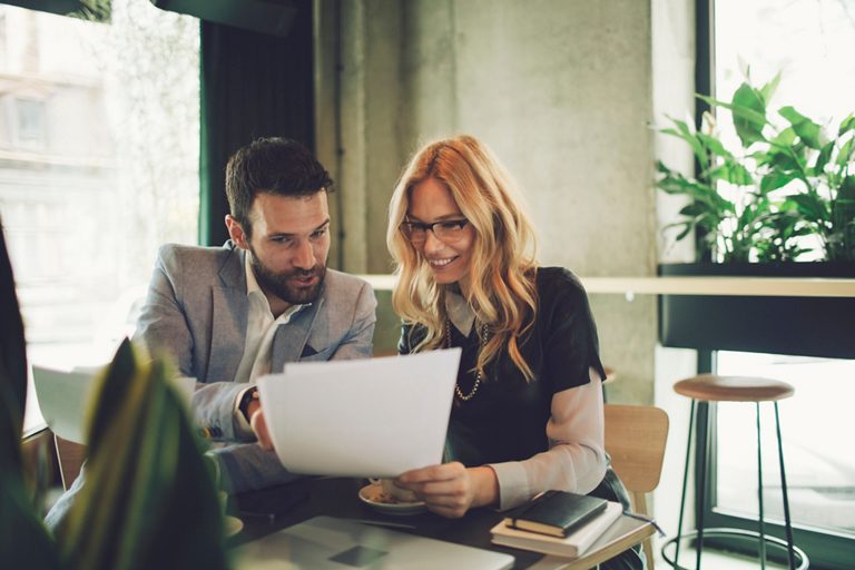 Business meeting, one on one. Businessman and his colleague businesswoman having meeting. Sitting and talking.