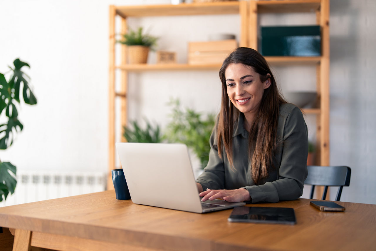 woman sitting at desk studying on laptop