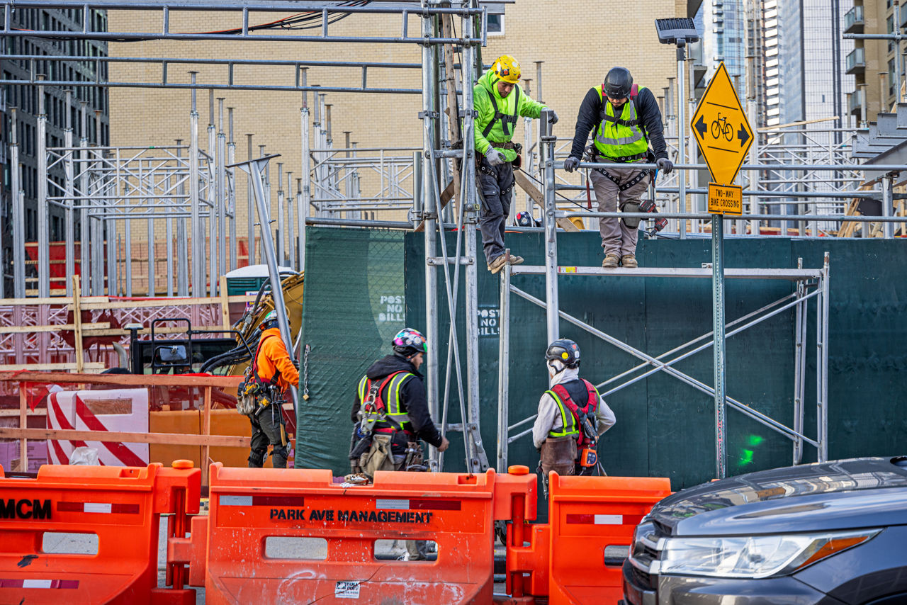 construction workers in safety vests on a job site