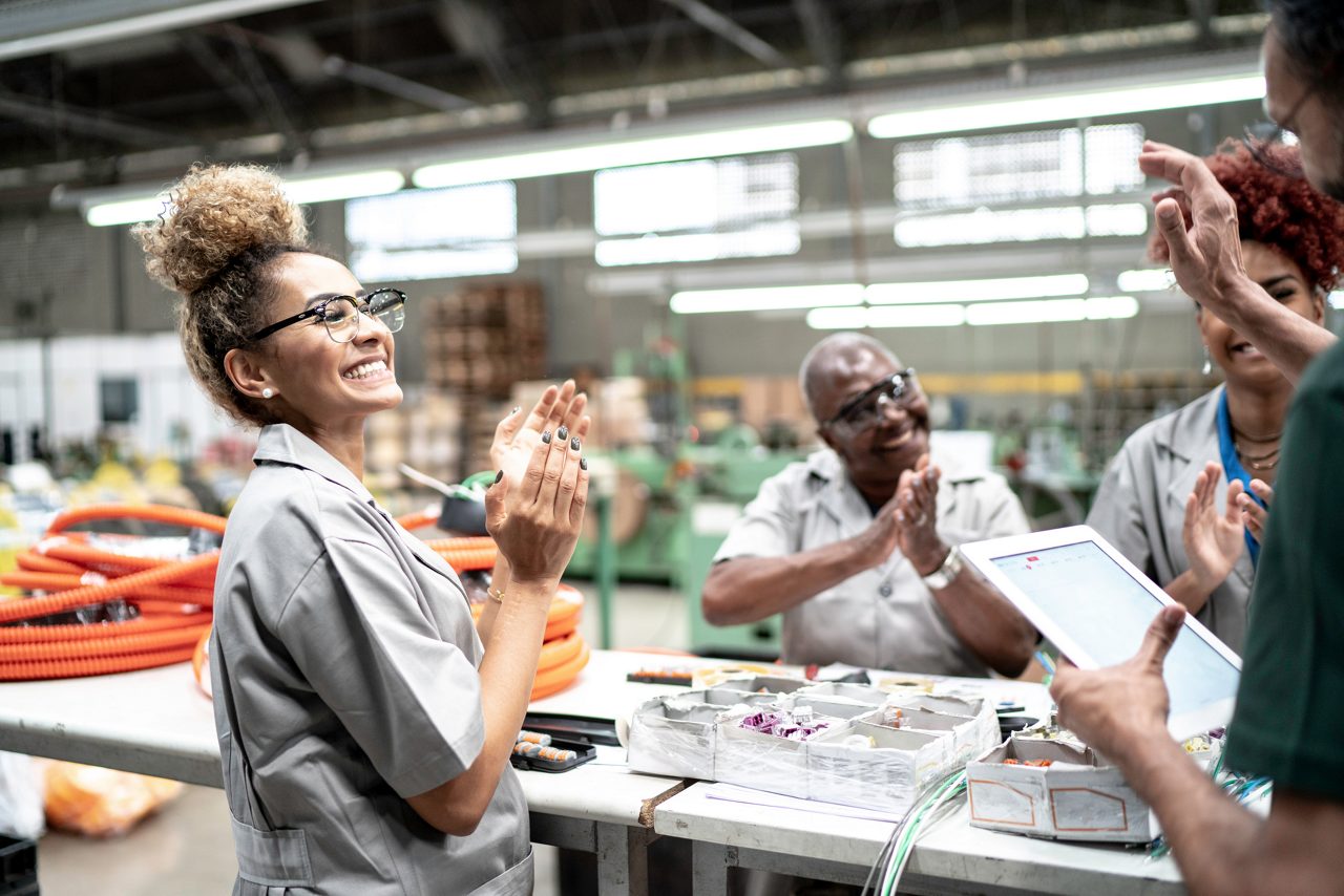 Manufacturing workers clapping