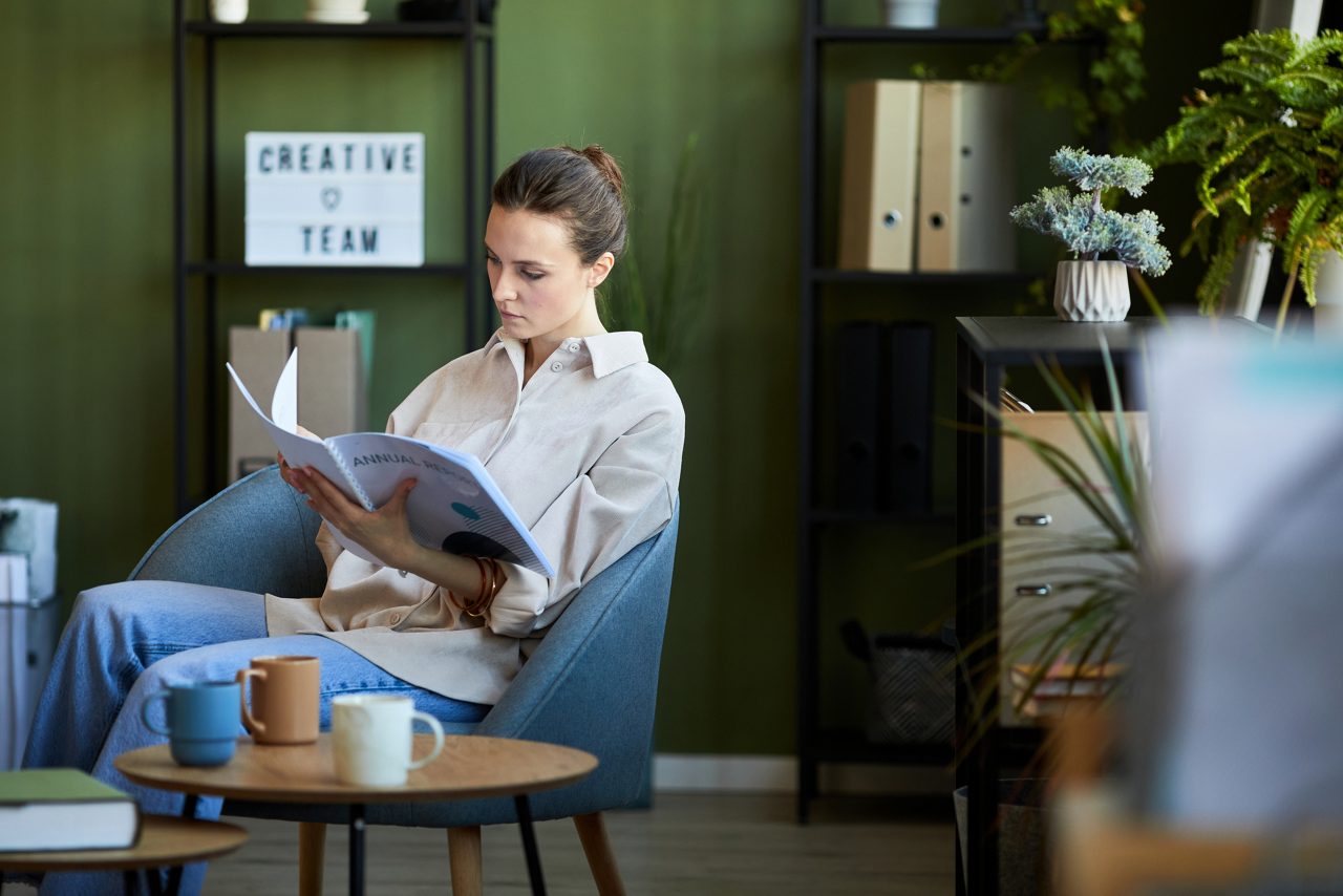 Woman reading employee handbook