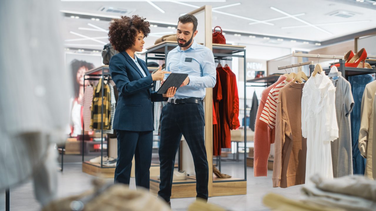 Woman manager talking to male employee in retail