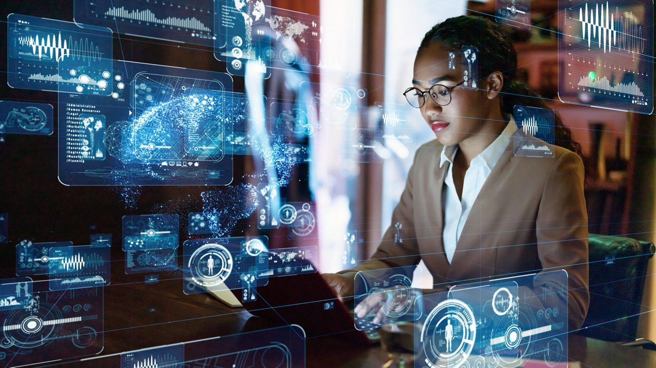 Woman looking at computer with digital symbols