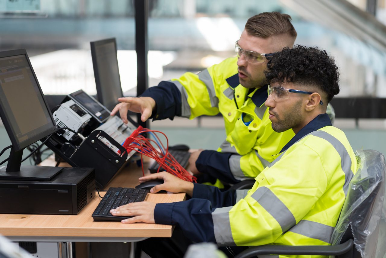 Two construction colleagues working at a computer