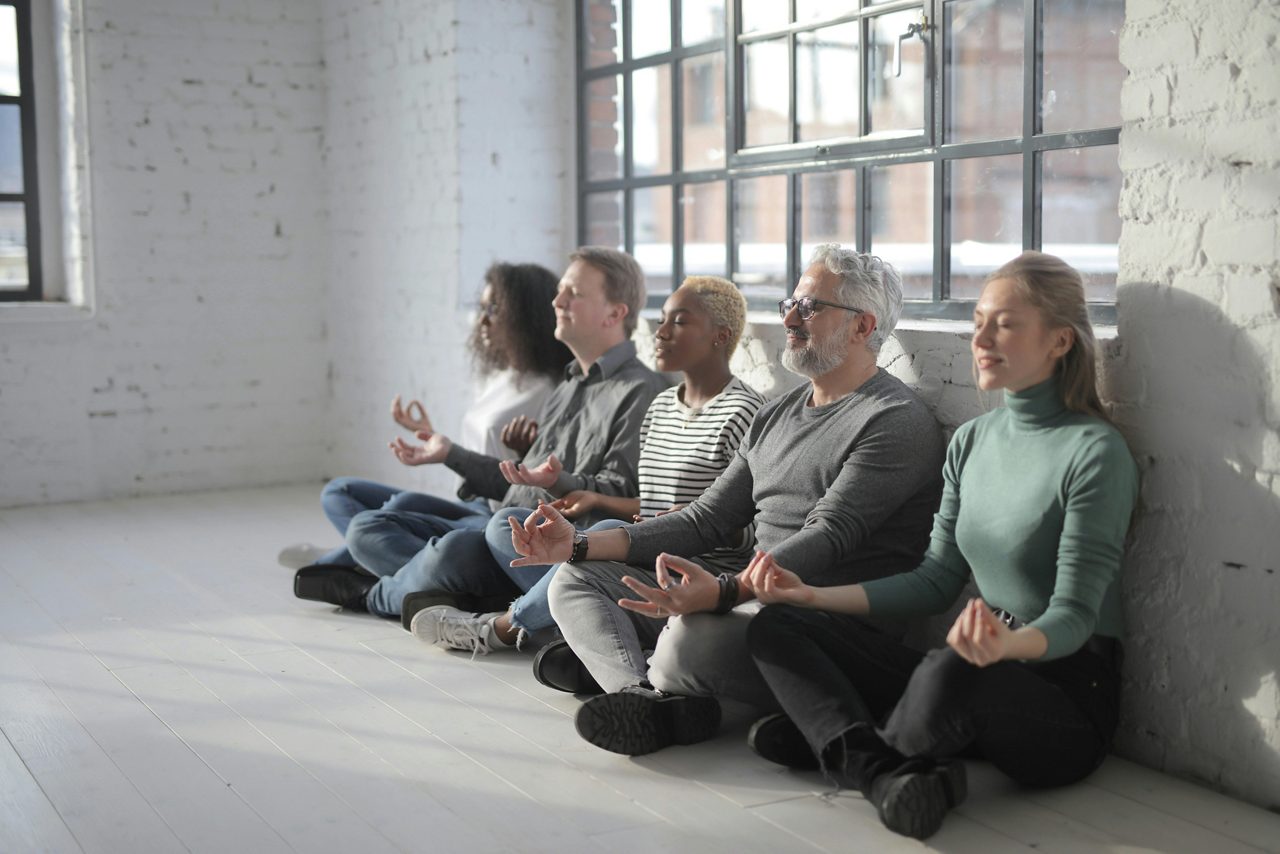 Group of people meditating at work