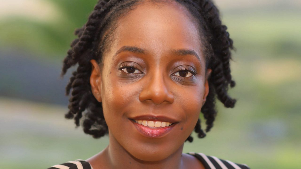 A portrait photo of a woman smiling