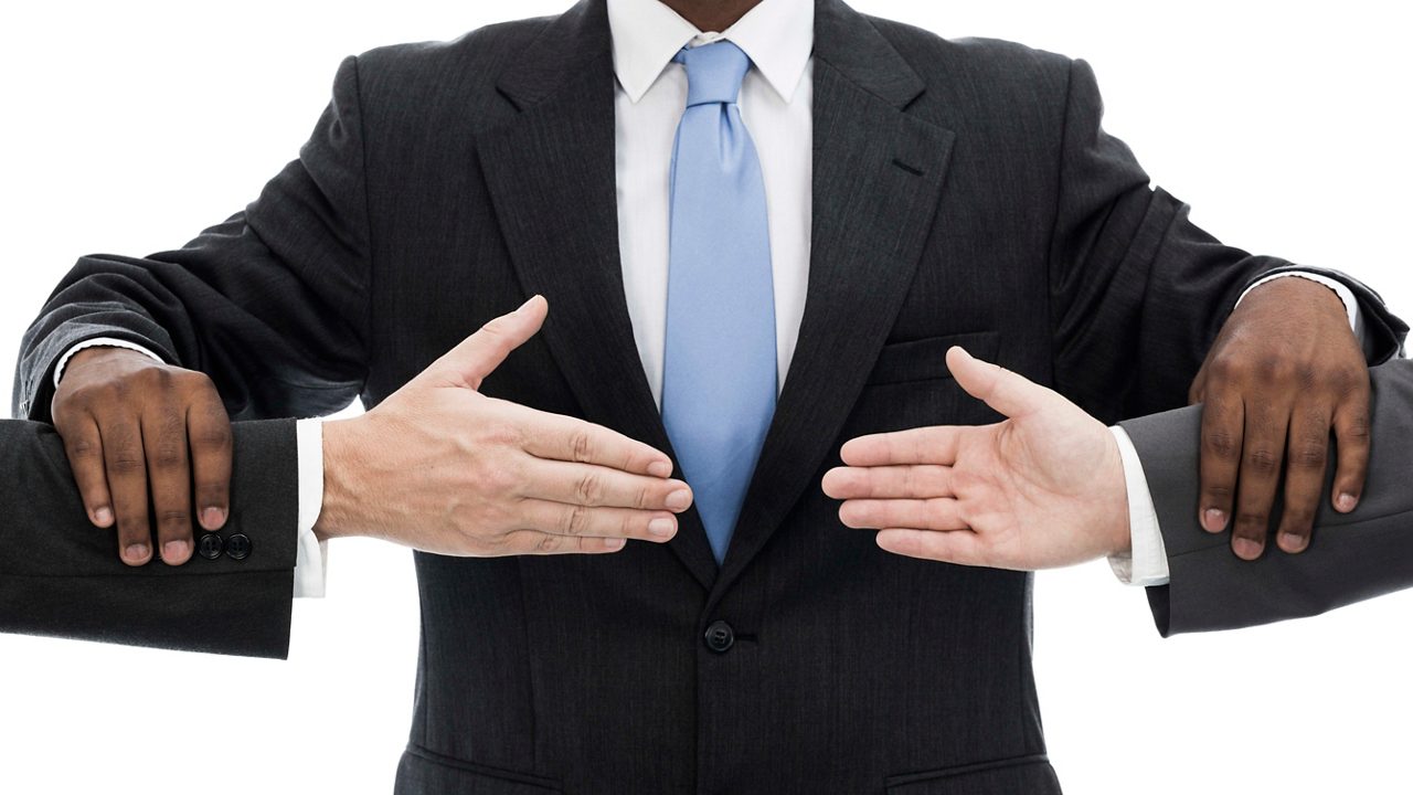 A group of businessmen with their hands outstretched.