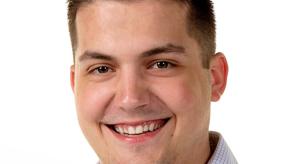 A smiling man in a blue shirt.