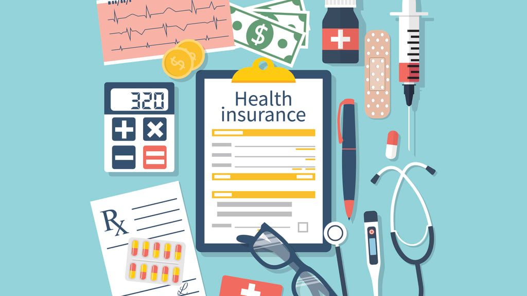 Health insurance concept with a clipboard, stethoscope and other medical items.