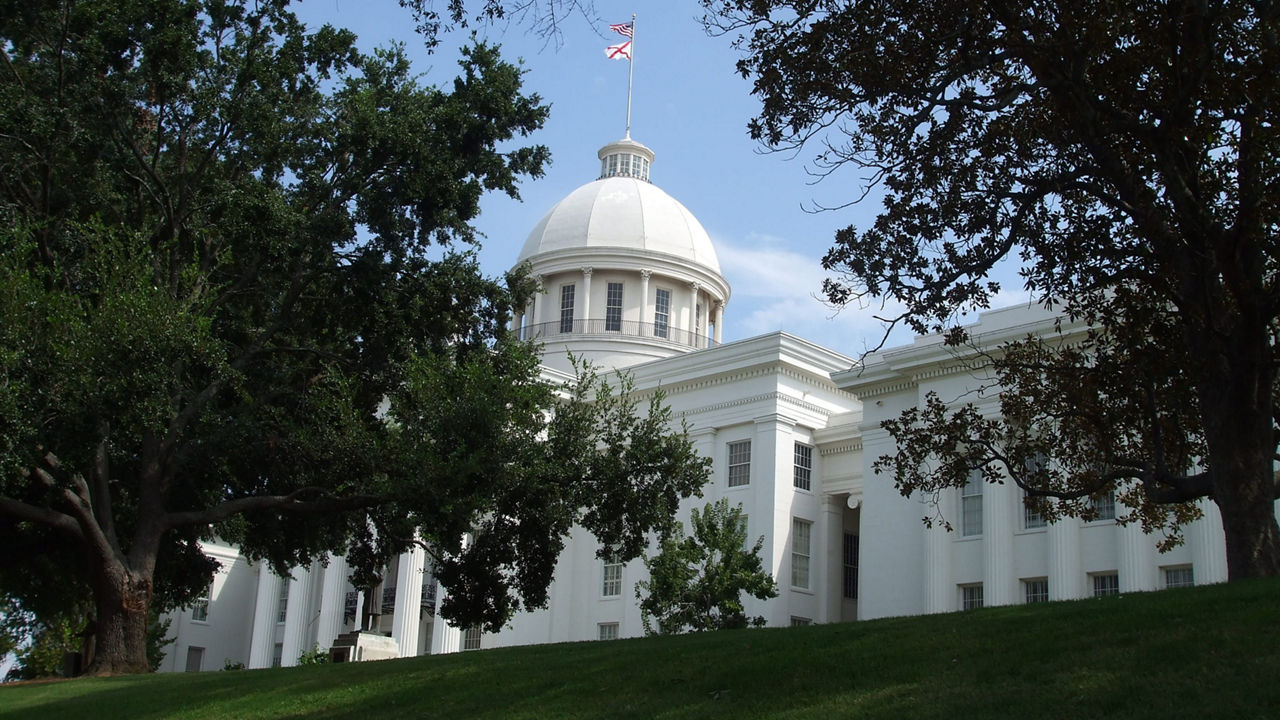 A white building with a dome on top of it.