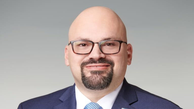 A bald man in a suit and tie.