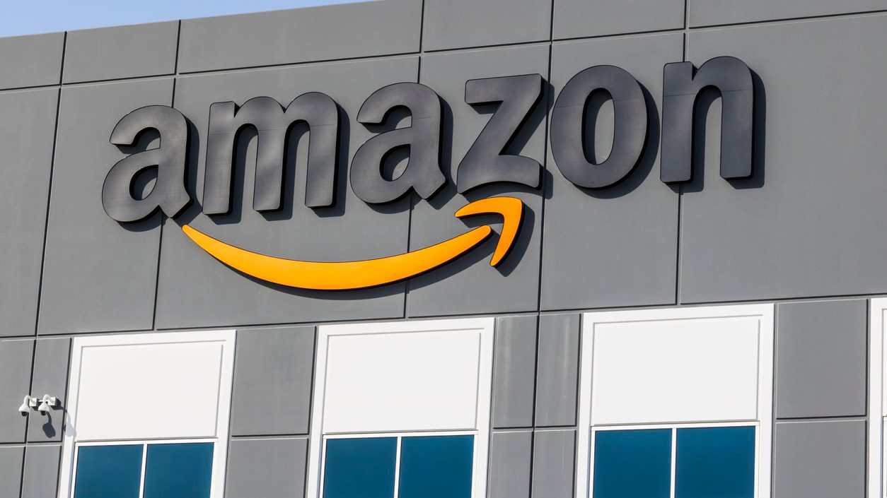 The amazon logo is seen on the side of a building.