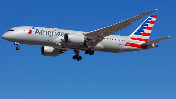 An american airlines airplane flying in the sky.