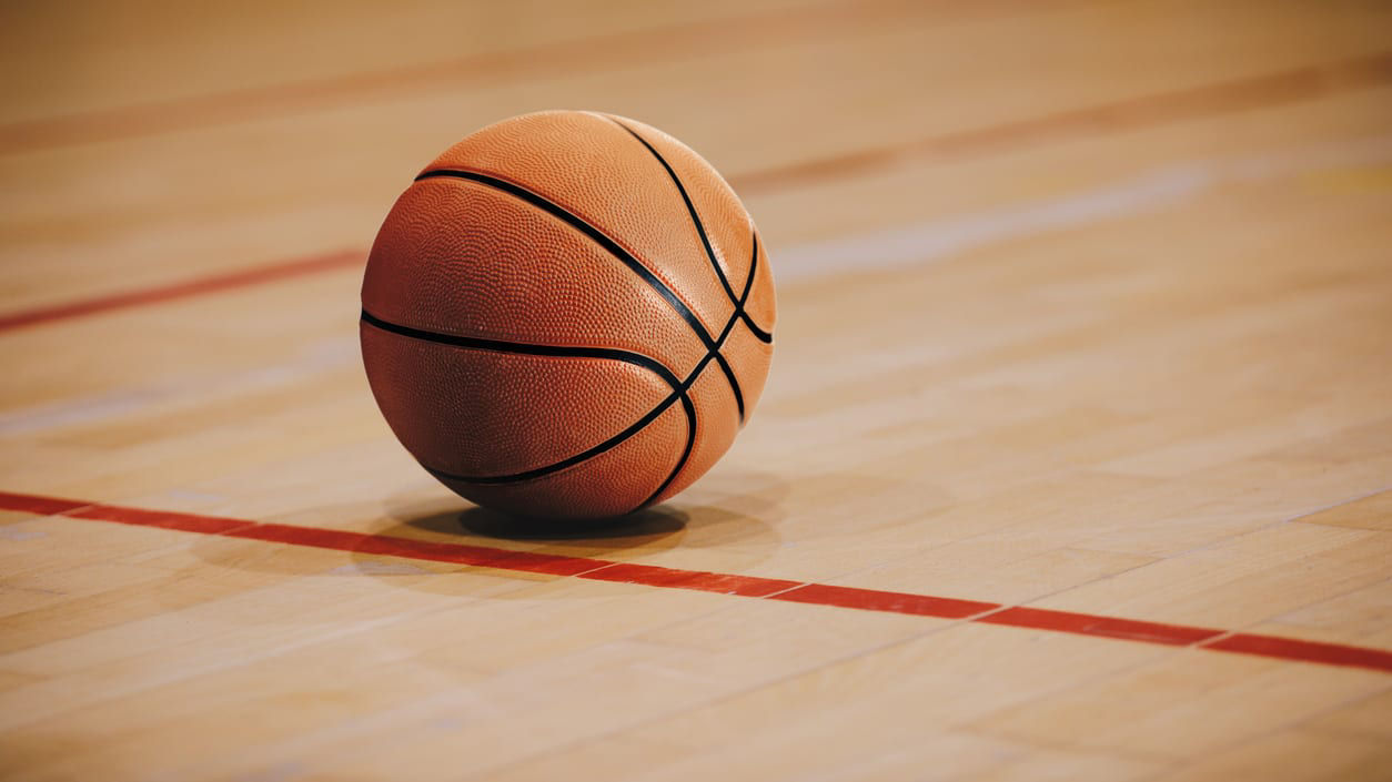 A basketball sitting on a wooden court.
