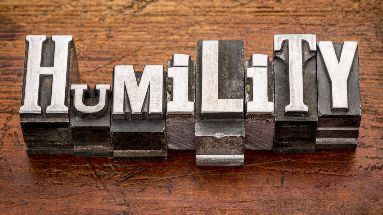 The word humility in metal type on a wooden background.