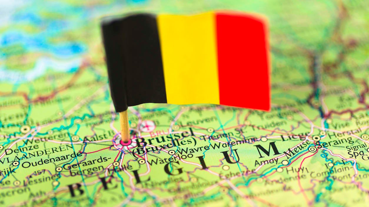 A flag is pinned on a map of belgium.