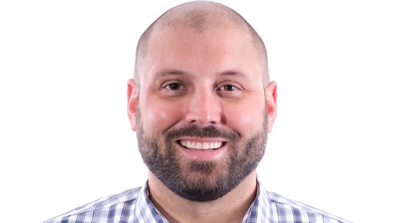 A man wearing a blue and white checkered shirt.