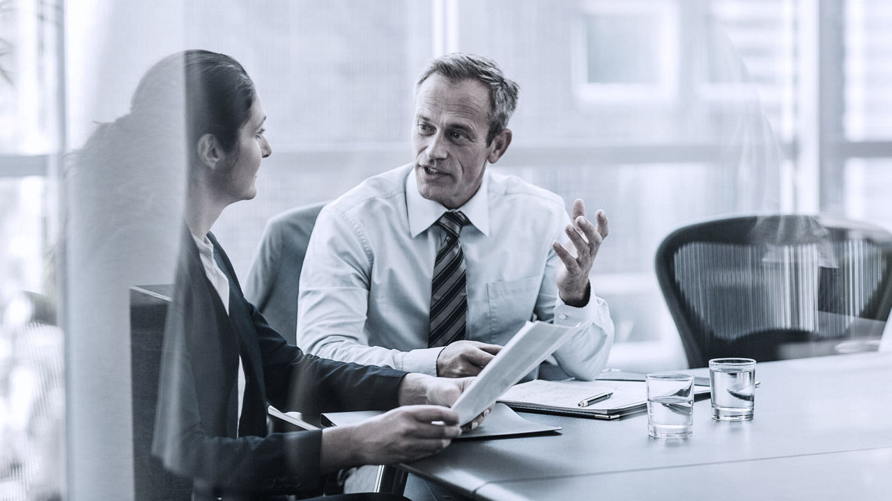 Two business people having a meeting in a conference room.