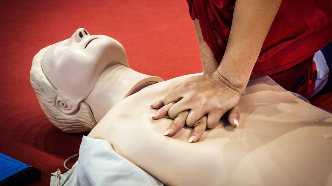 A mannequin demonstrating how to perform a cpr on a mannequin.