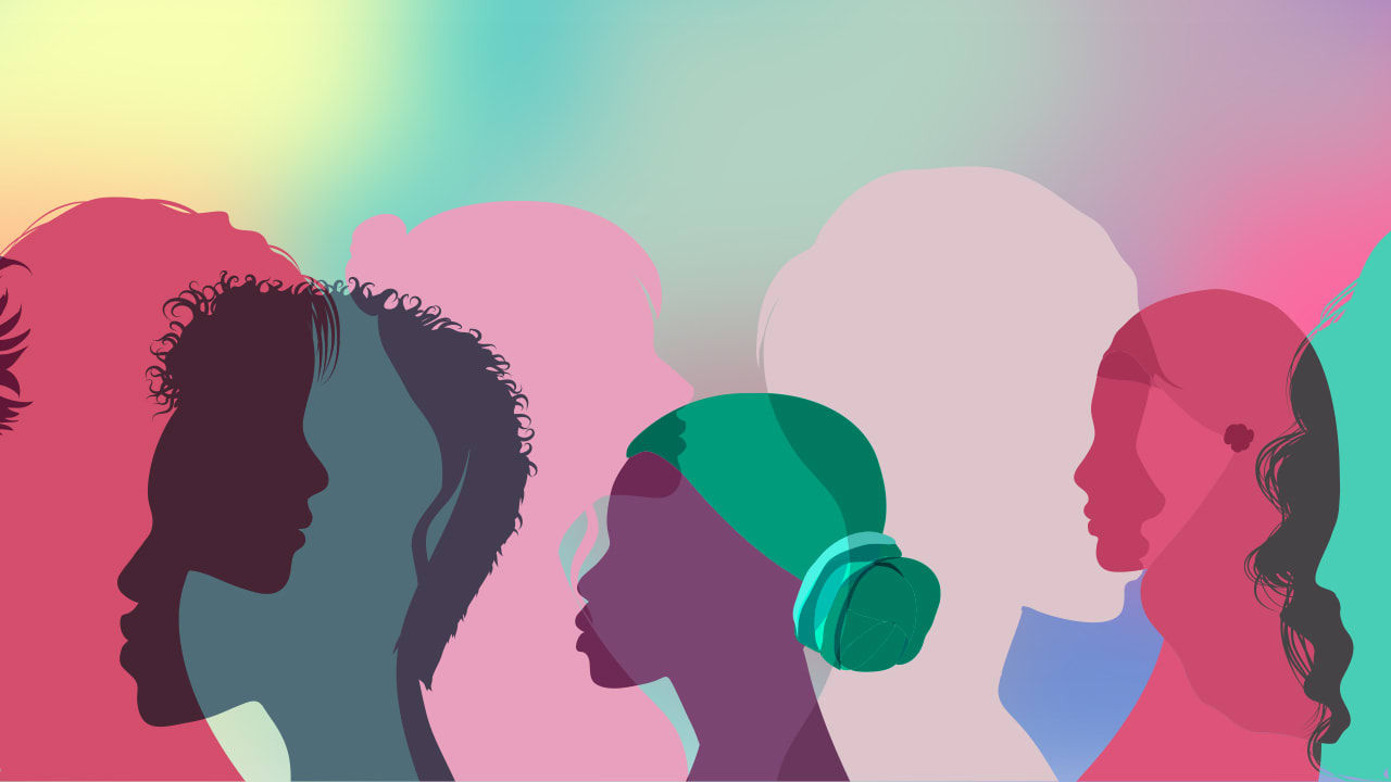 A group of people silhouetted against a colorful background.