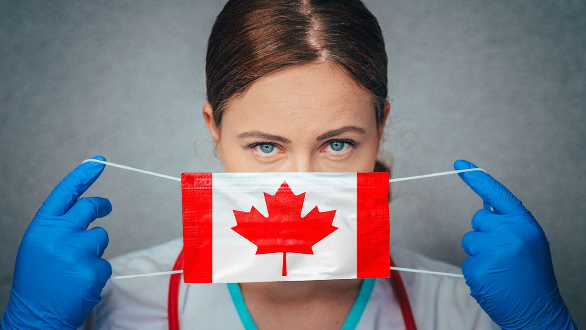 A female doctor wearing a canadian flag mask.