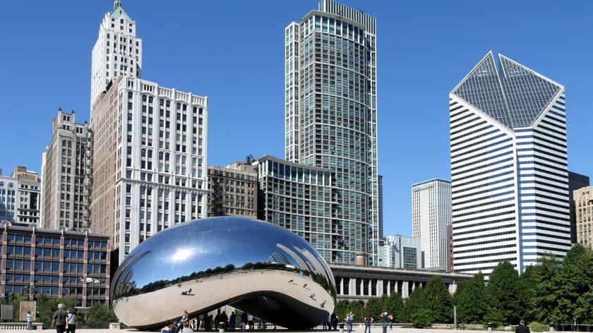 Chicago's cloud gate sculpture in front of skyscrapers.
