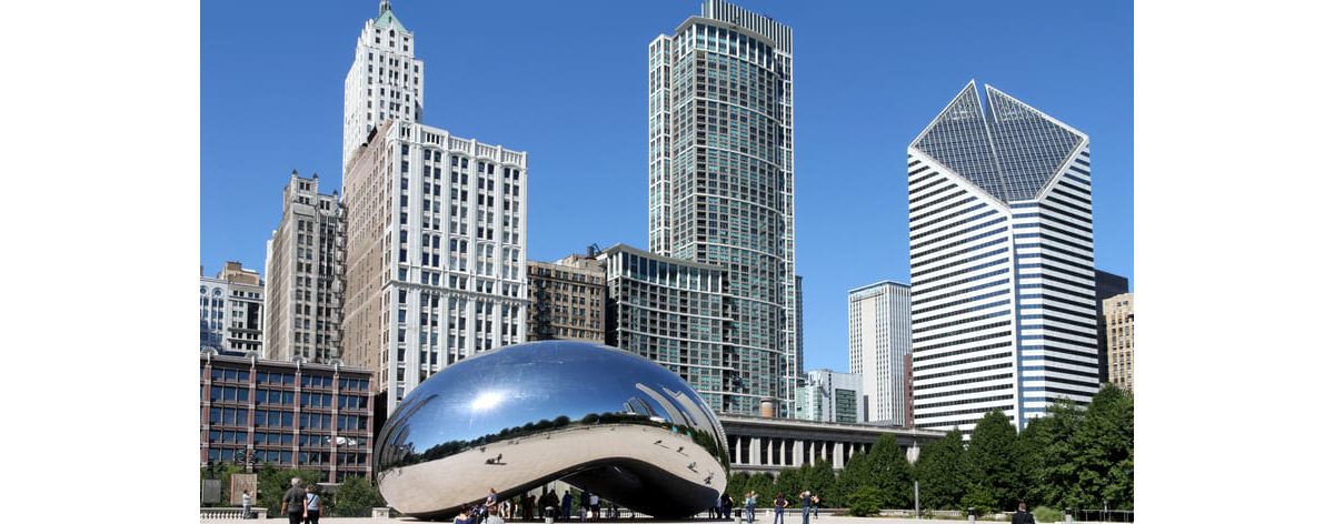 Chicago's cloud gate sculpture in front of skyscrapers.