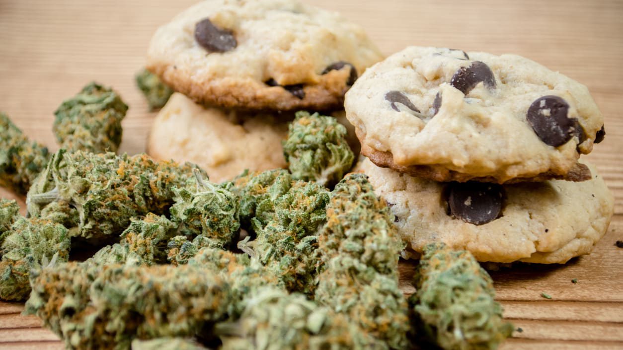 Cbd cookies and marijuana on a wooden table.