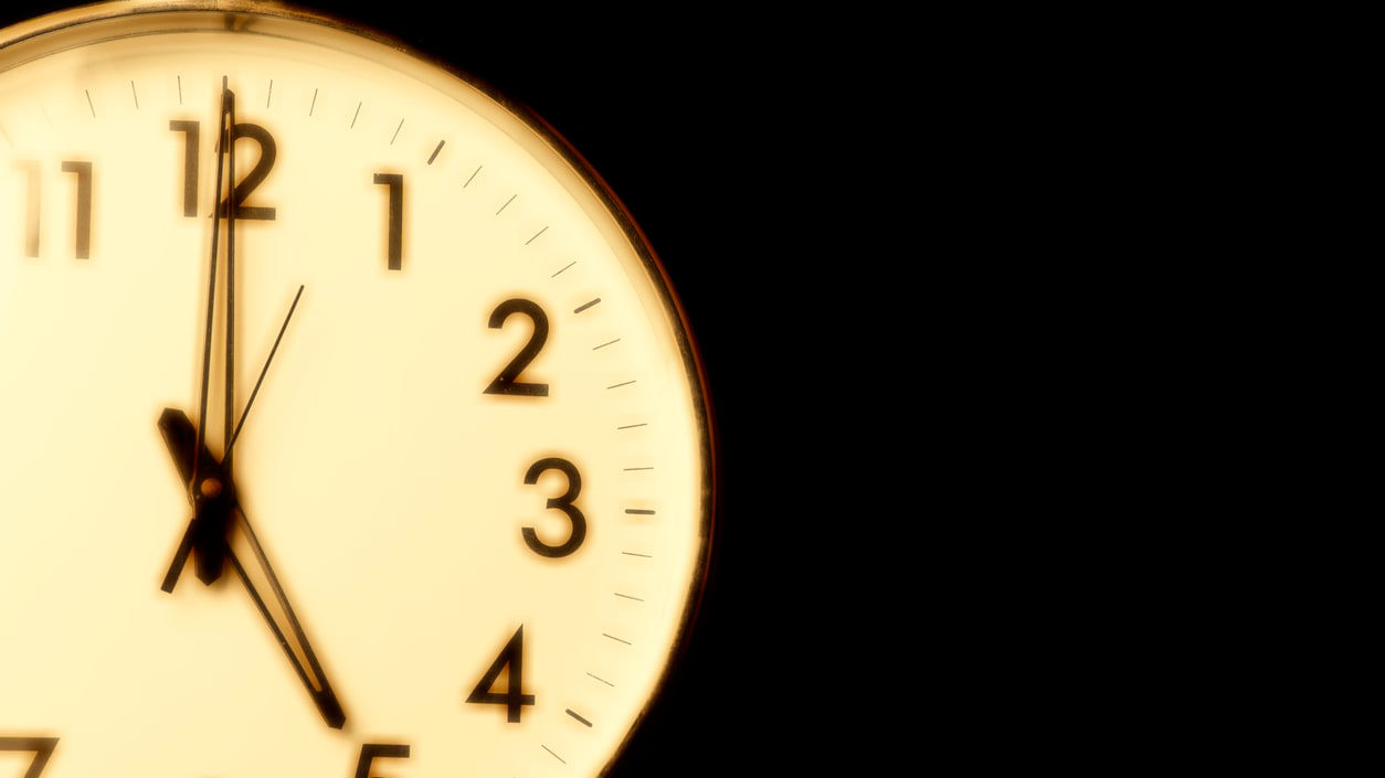 A clock on a black background.