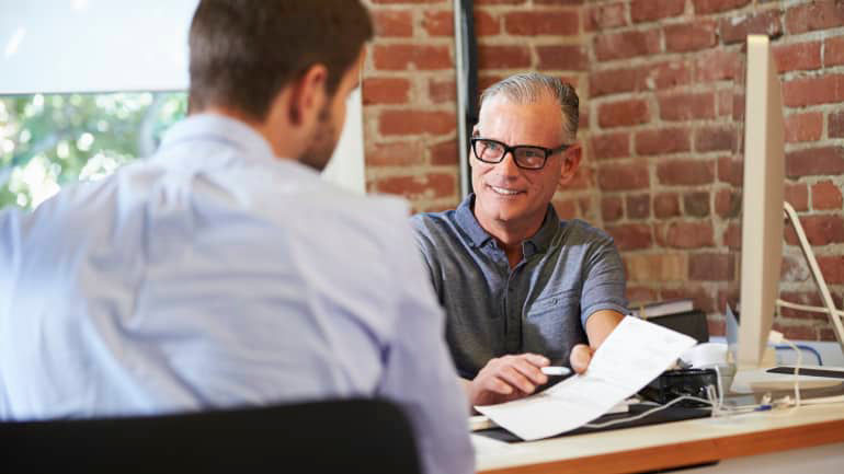 A man in a blue shirt actively engages in conversation, expressing his thoughts and concerns while receiving guidance.