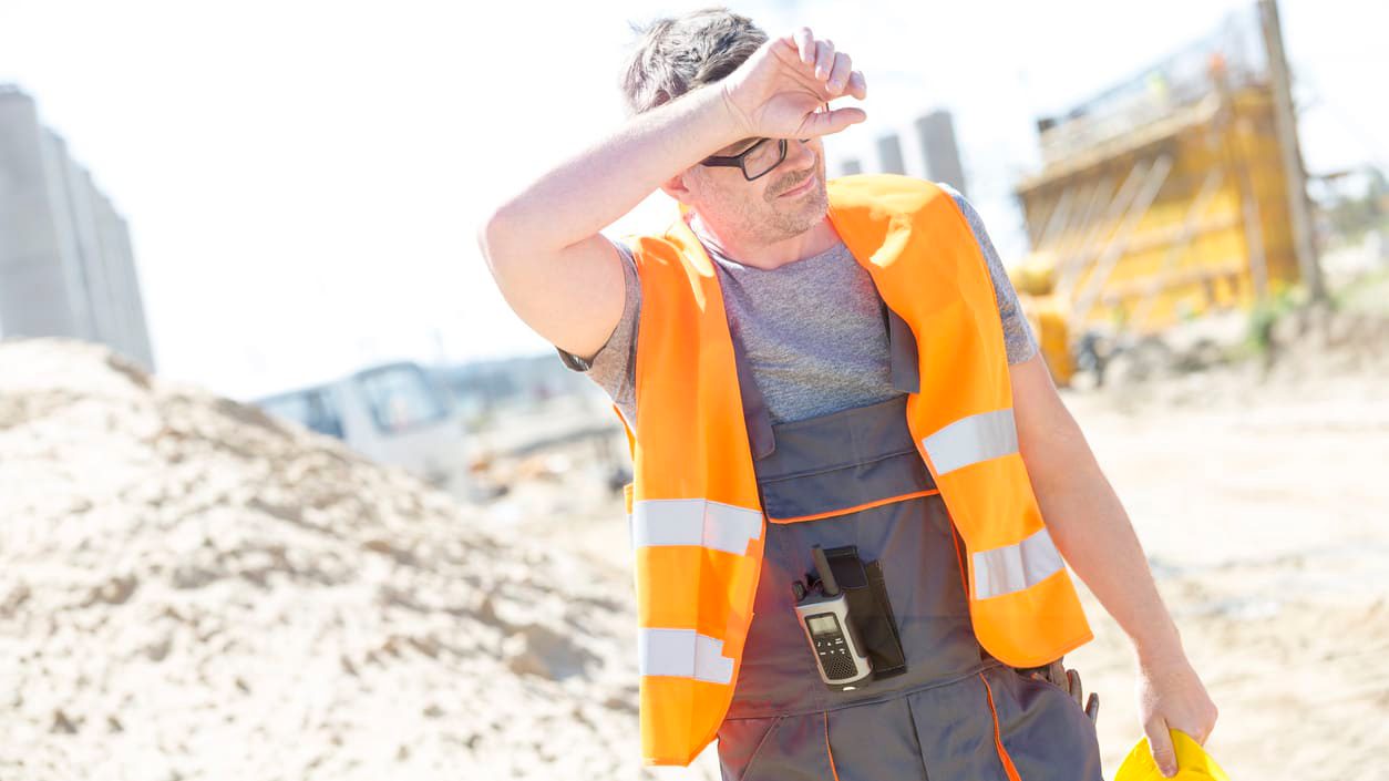 A construction worker wearing an orange vest.