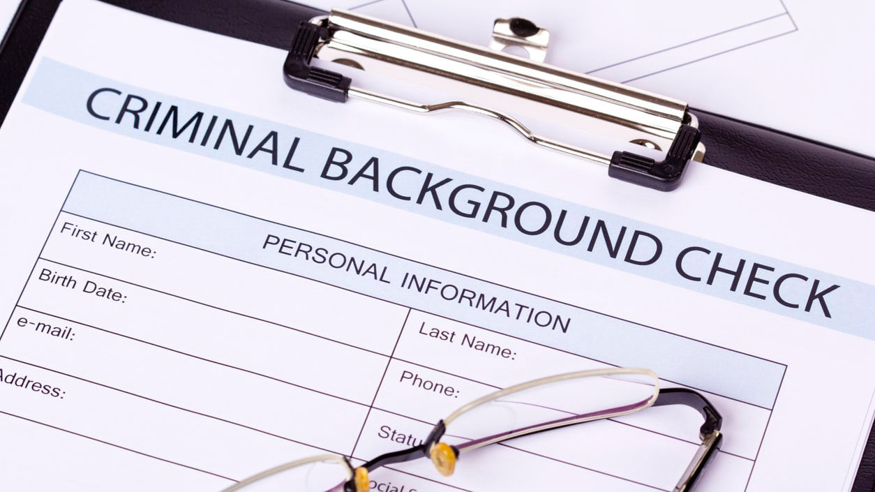 A clipboard with a criminal background check on it.