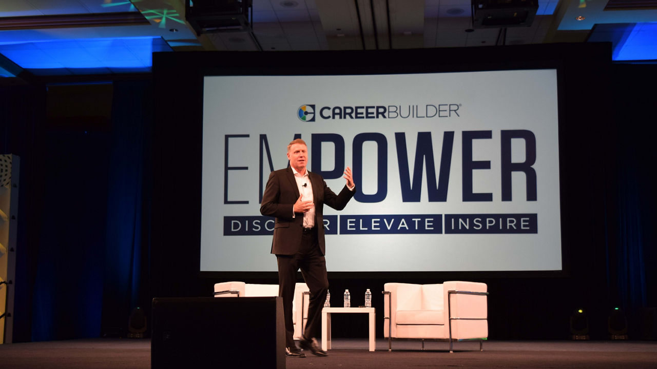 A man on stage at the enpower conference.
