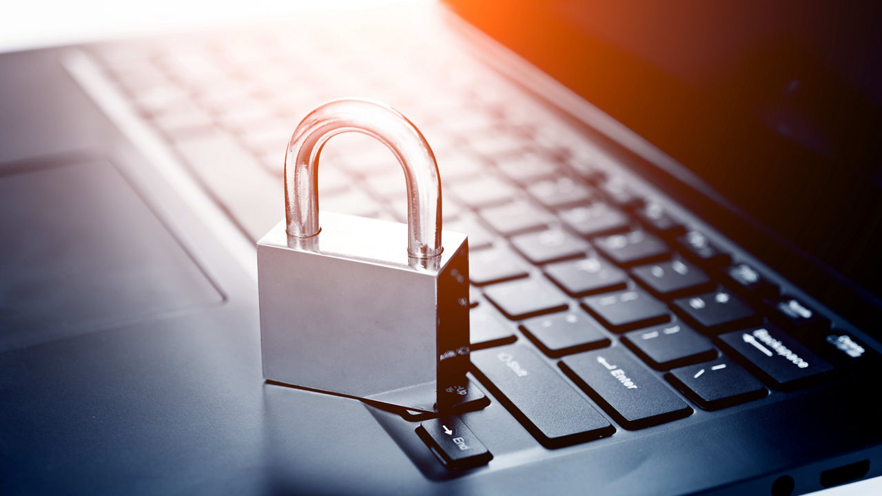 A padlock on top of a laptop computer.