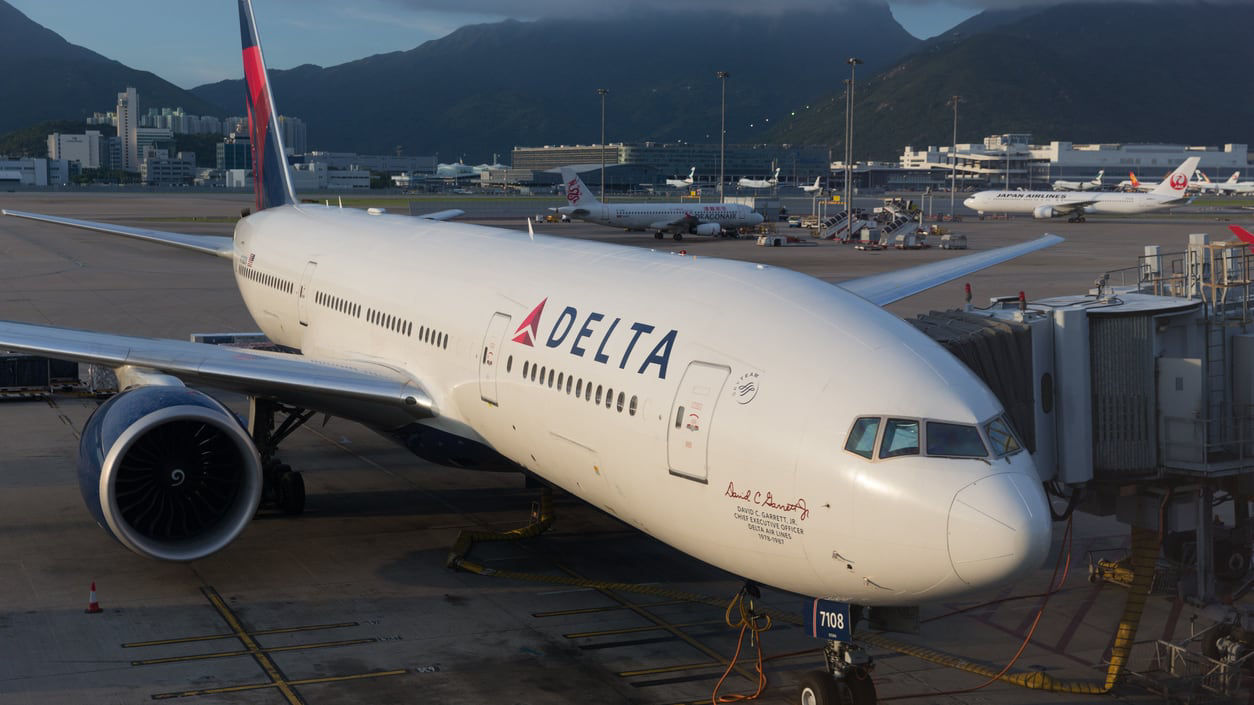 A delta airplane parked on the tarmac.