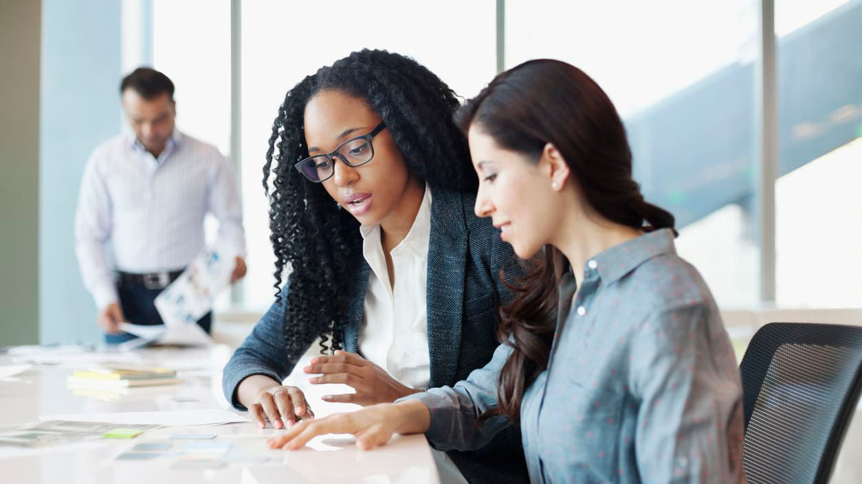 A group of business people working together in an office.
