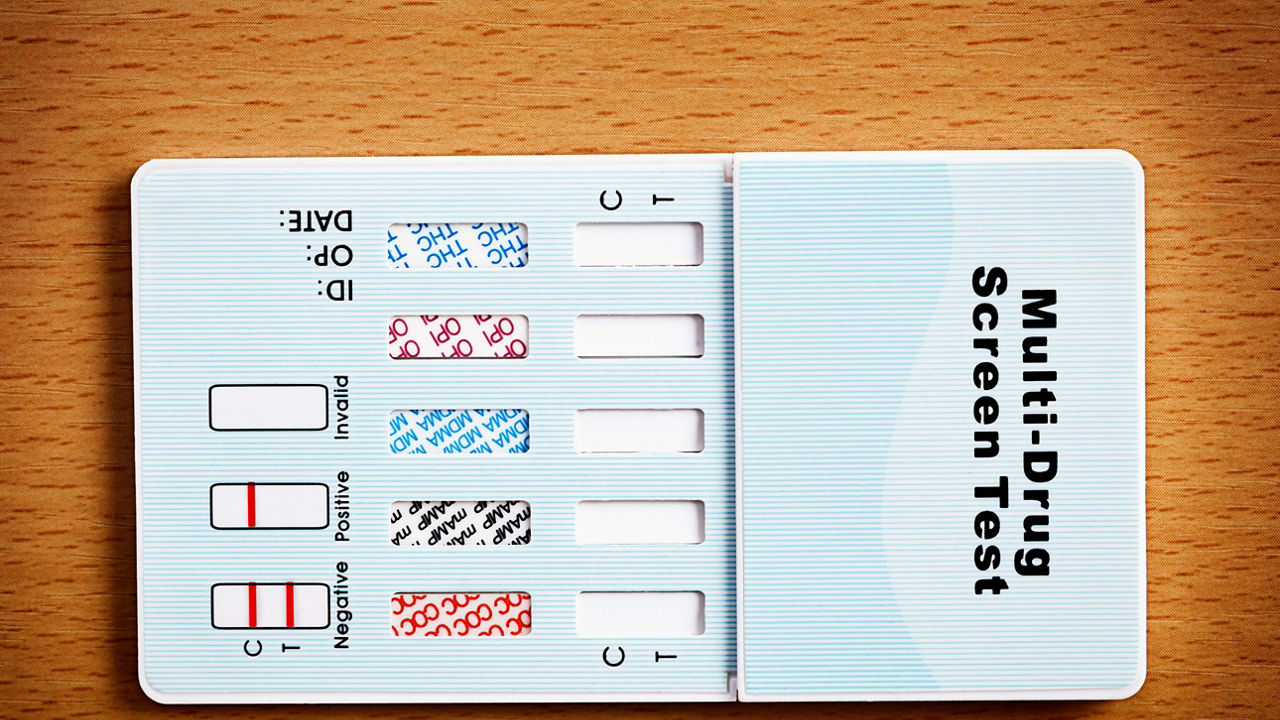 A card with a blood test sitting on top of a wooden table.