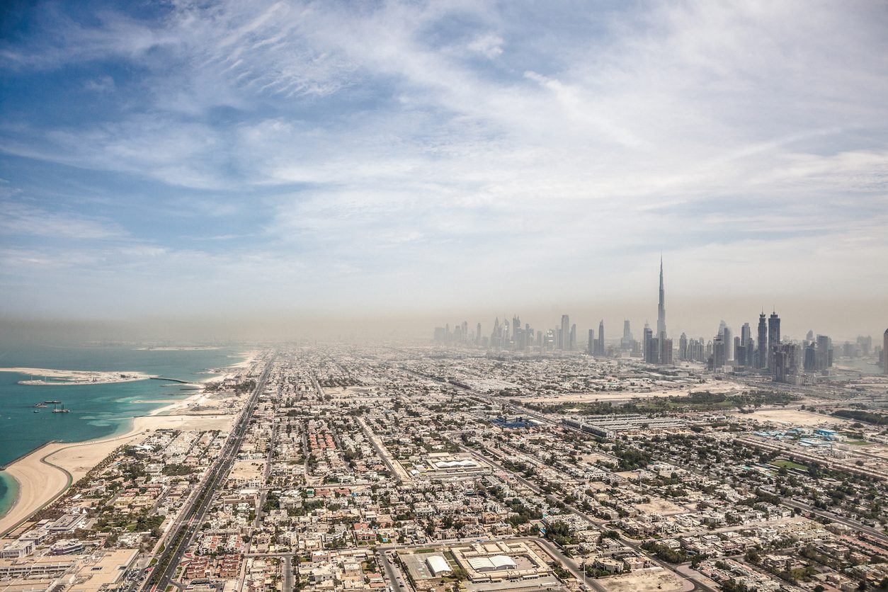 Aerial view of downtown Dubai in United Arab Emirates. Foggy sand storm day over the tall skyscrapers and office buildings on Sheikh Zayed Road.