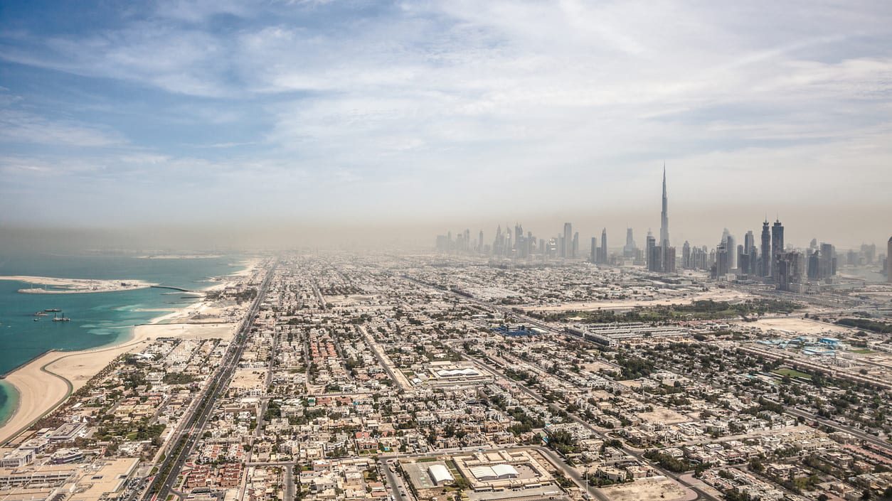 An aerial view of the city of dubai and the burj khalifa.