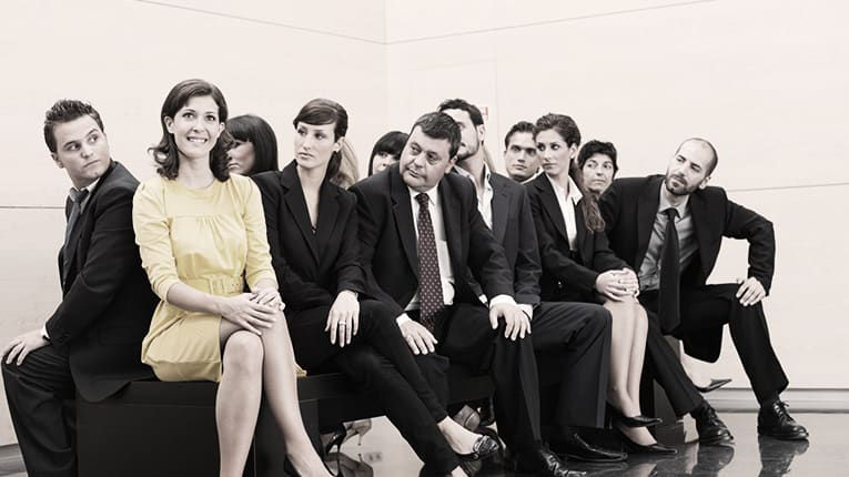 A group of business people posing for a photo.