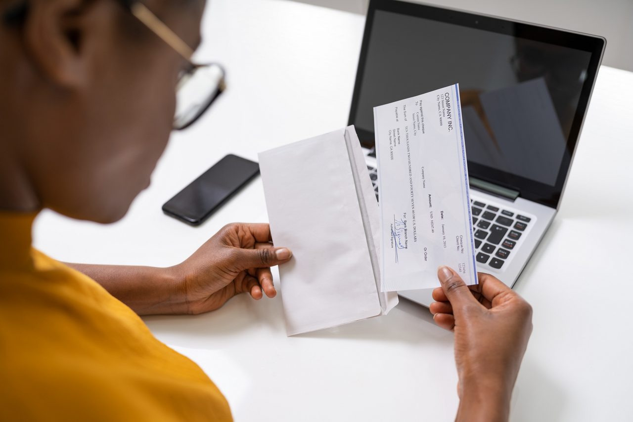 Woman looking at workers comp check