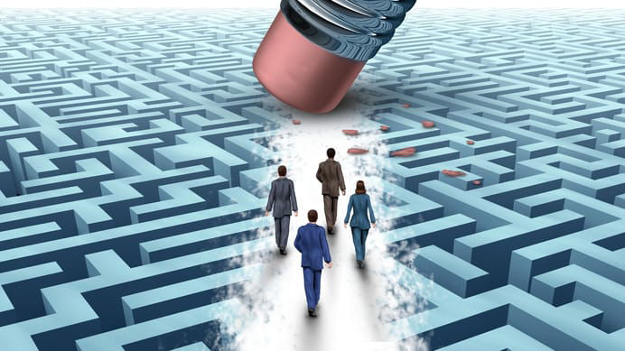 A group of people walking through a maze with a pencil.