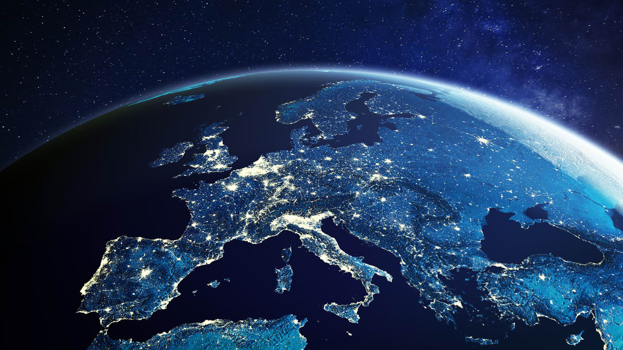 An image of the earth at night showing the lights of europe.