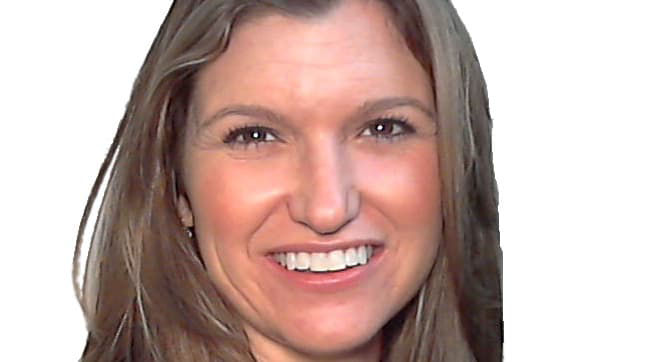 A woman with long hair smiling for the camera.