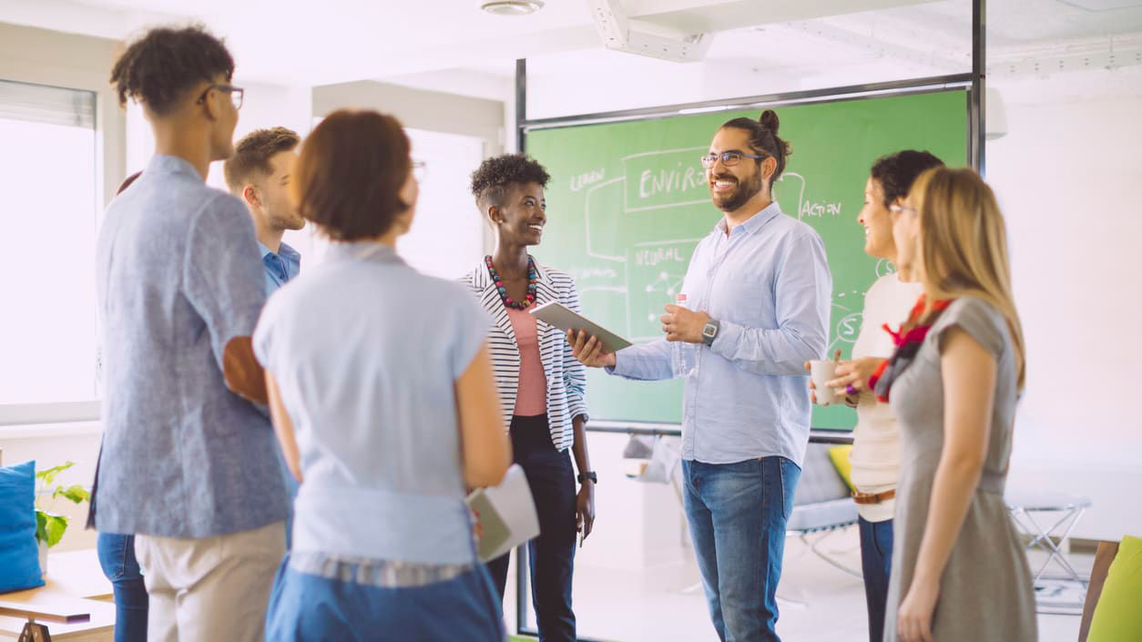 group of young people standing around in classroom