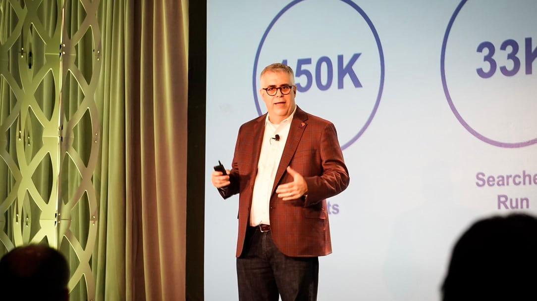 A man standing in front of a screen giving a presentation.