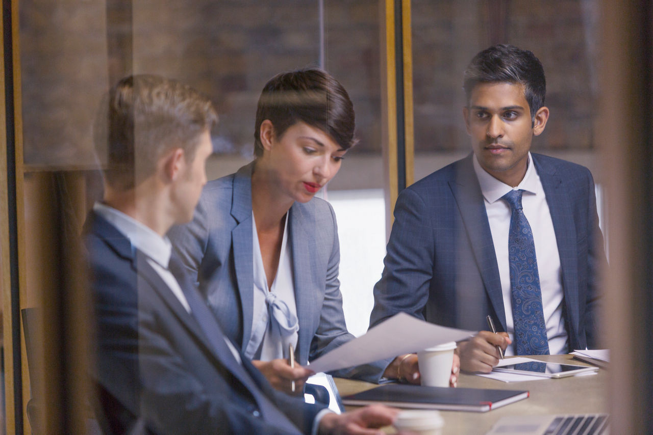 Three professionals in a meeting room