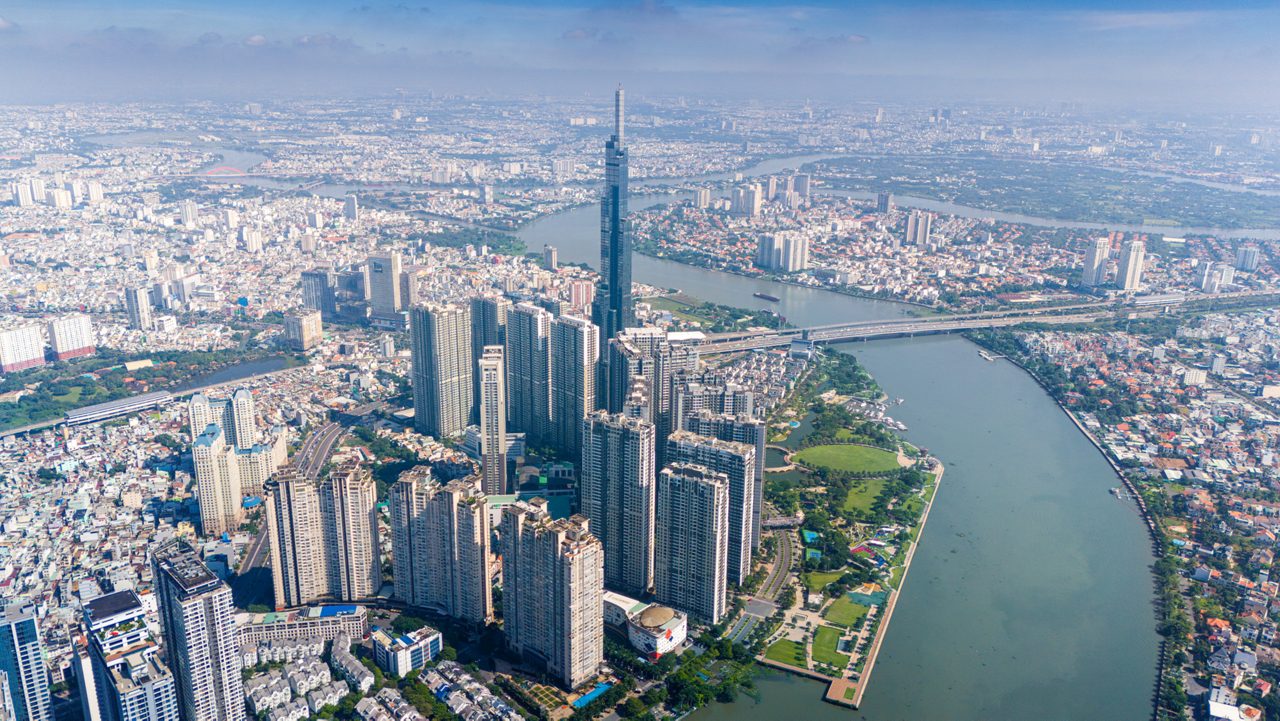 aerial view of early morning at Landmark 81 is a super tall skyscraper in center Ho Chi Minh City, Vietnam and Saigon bridge with development buildings, energy power infrastructure. Travel concept.
