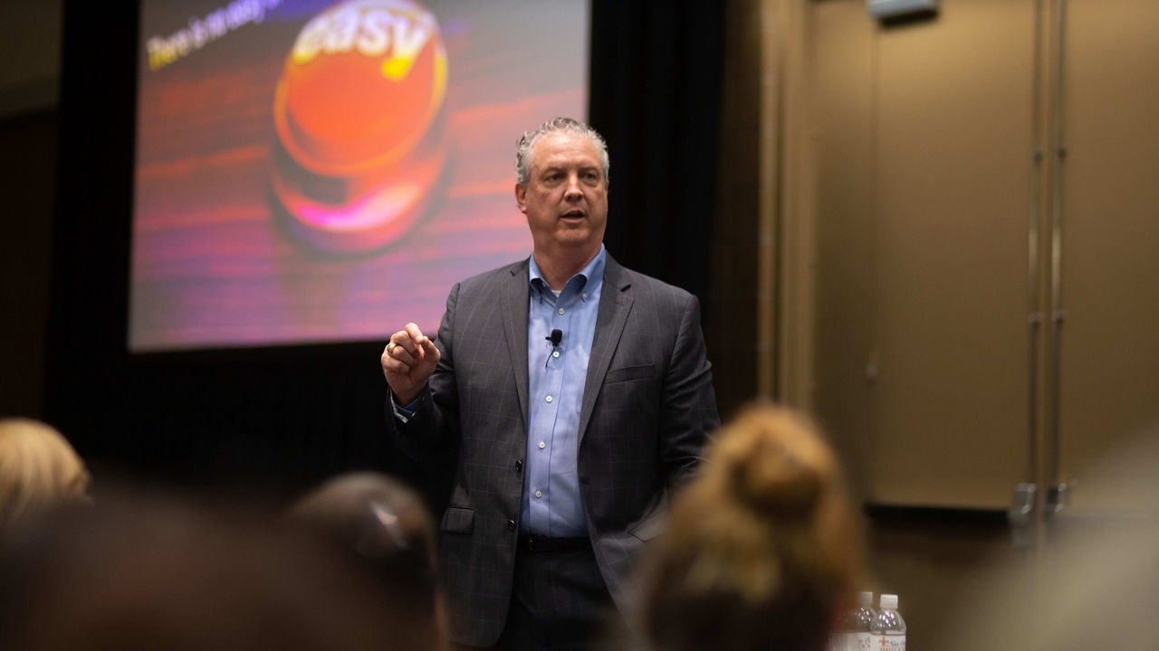 A man giving a presentation in front of an audience.